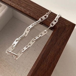 Minimalist S925 sterling silver chain bracelet with hollow floral pattern on wood frame
