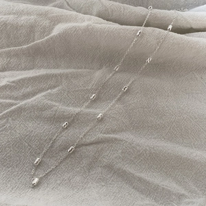 Detailed close-up of S925 sterling silver chain with laser-engraved rice beads