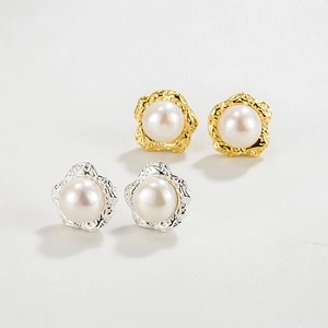 Macro shot of irregular metal pearl studs in gold and silver showing realistic textures