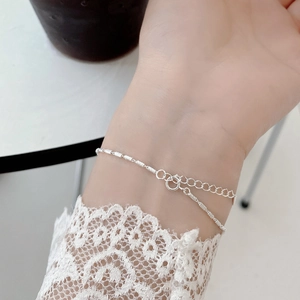 Minimalist S925 sterling silver chain bracelet with textured tube beads on female wrist