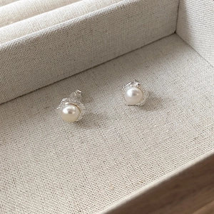 Irregular textured metal pearl earrings in 925 sterling silver on jewelry box