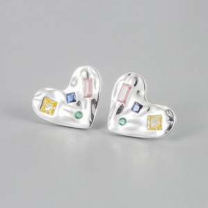 Detail of hammered silver heart studs with colorful rectangular and square cubic zirconia