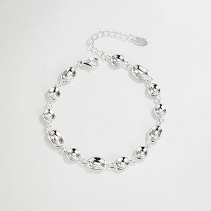 Macro detail of silver S925 sterling silver pea chain bracelet with polished oval links