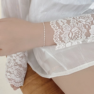 Close-up of a minimalist S925 sterling silver thin chain bracelet on a woman's wrist