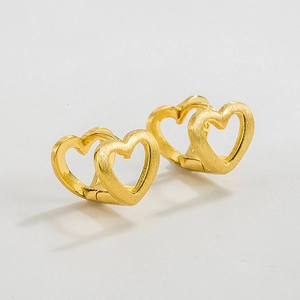 Close-up of golden brushed heart hoop earrings showing the S925 sterling silver hallmark