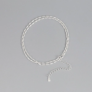 Macro shot of 925 sterling silver dual-layer chain with adjustable S925 engraved tag