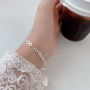 Detail of silver heart-link bracelet showing adjustable extender chain and S925 finish