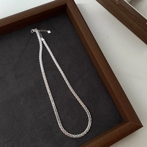 Close-up of S925 sterling silver twisted rope chain with lobster clasp and heart charm