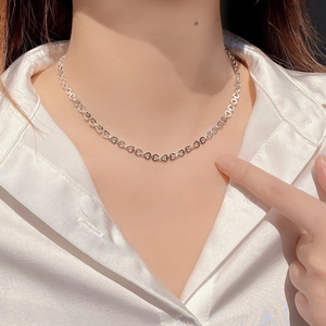 Elegant S925 sterling silver heart-shaped link necklace worn by a model in soft light