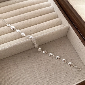 Detailed view of S925 sterling silver bean link bracelet with lobster clasp and mirror finish