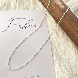 Detail view of 925 sterling silver twist chain necklace on decorative fashion card