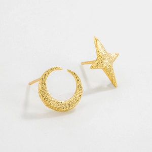 Detailed view of matte gold S925 sterling silver asymmetrical moon and star stud earrings
