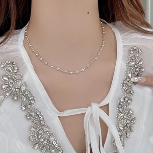 Detail of S925 sterling silver beaded necklace showing fit on model neck