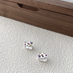Detailed macro shot of S925 sterling silver hallmark and colorful zircon inlay craftsmanship
