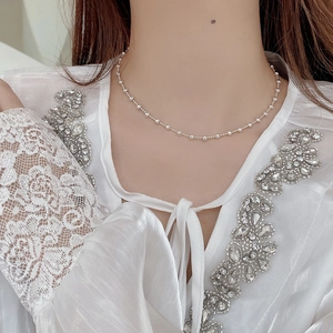 Close-up of S925 sterling silver beaded choker necklace on a model's collarbone