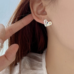 Minimalist 925 sterling silver heart studs with colorful zircons worn on the ear