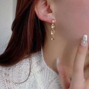 Elegant 925 sterling silver gold layered pea drop earrings shown on model