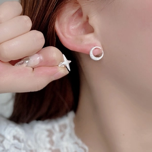 Minimalist 925 sterling silver asymmetrical star and moon stud earrings on model