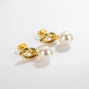 Detail showing gold knotted stud earrings with large lustrous white pearls and S925 stamp