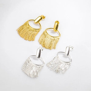Detail of silver and gold long tassel earrings set showing fine metallic texture and drape