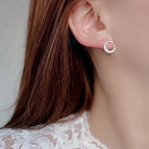 Macro shot of a 925 sterling silver crescent moon stud earring with sparkling cubic zirconia