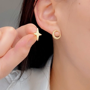 925 silver asymmetric star and moon stud earrings with a textured matte gold finish