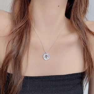 Close-up of 925 sterling silver retro coin necklace with Queen Elizabeth II engraving