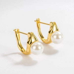 Detailed view of gold U-shaped S925 silver earrings with lustrous white pearls