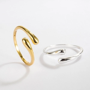 Detail of gold and silver S925 sterling silver drop rings showing the open design and stamp