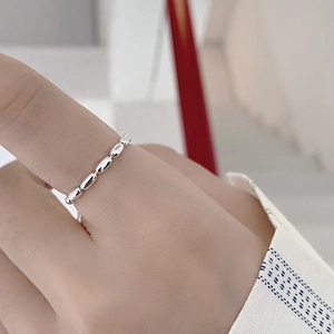 Close-up of minimalist S925 sterling silver beaded adjustable chain ring on finger