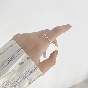 Minimalist S925 sterling silver beaded ring on a model index finger for stacking