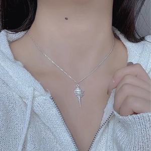 Close-up of a S925 sterling silver conch shell pendant necklace worn on a woman neck
