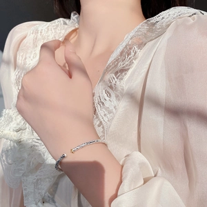 Macro detail of S925 silver cuff bracelet with vintage floral relief and gold accents