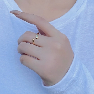 Close-up of minimalist gold S925 sterling silver open ring with teardrop design on finger