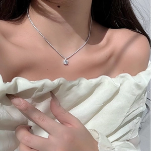 Close-up of S925 sterling silver necklace with a square zircon pendant on neck