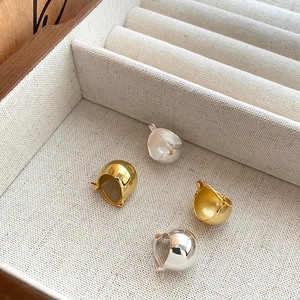 Polished S925 sterling silver and gold dome earrings set on jewelry display