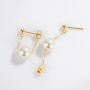 Detail of round pearl drop earrings with 925 silver gold chain and butterfly back closure