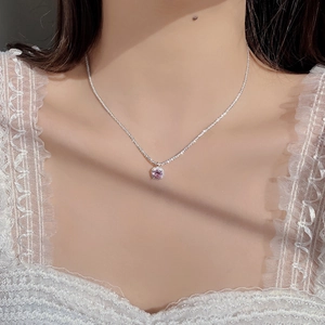 Close-up of S925 sterling silver necklace with pink round stone and zircon halo on neck