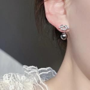 French retro silver knot stud earrings with dark grey glass pearls on model