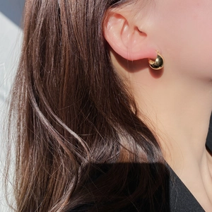 Minimalist 925 sterling silver ball stud earrings in polished gold finish on model