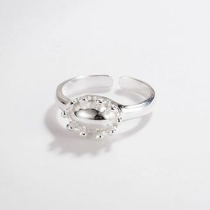 Detail of adjustable S925 sterling silver ring with oval crown and beaded edge design