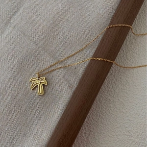 Elegant gold palm tree pendant necklace with delicate chain for summer vacation style