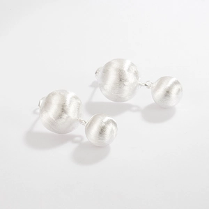 Detailed macro view of S925 sterling silver earrings with brushed metal double ball texture