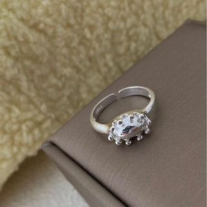 Macro shot of S925 sterling silver ring showing the inner stamp and sun-shaped bead edge