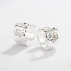 Macro view of S925 sterling silver hoop earrings featuring heart-shaped zircon stones