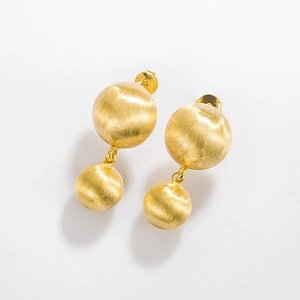 Macro detail of S925 sterling silver stamp on brushed matte gold sphere earrings