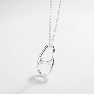 Close-up of minimalist S925 sterling silver pig nose geometric pendant necklace