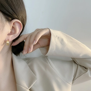 Gros plan de boucles d'oreilles créoles dorées à trois couches en argent S925 épuré