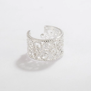 Detailed macro view of S925 sterling silver ear cuff with hollow lace floral pattern