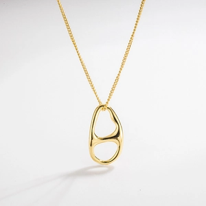 Detail of gold geometric hollow pendant with polished finish and delicate link chain